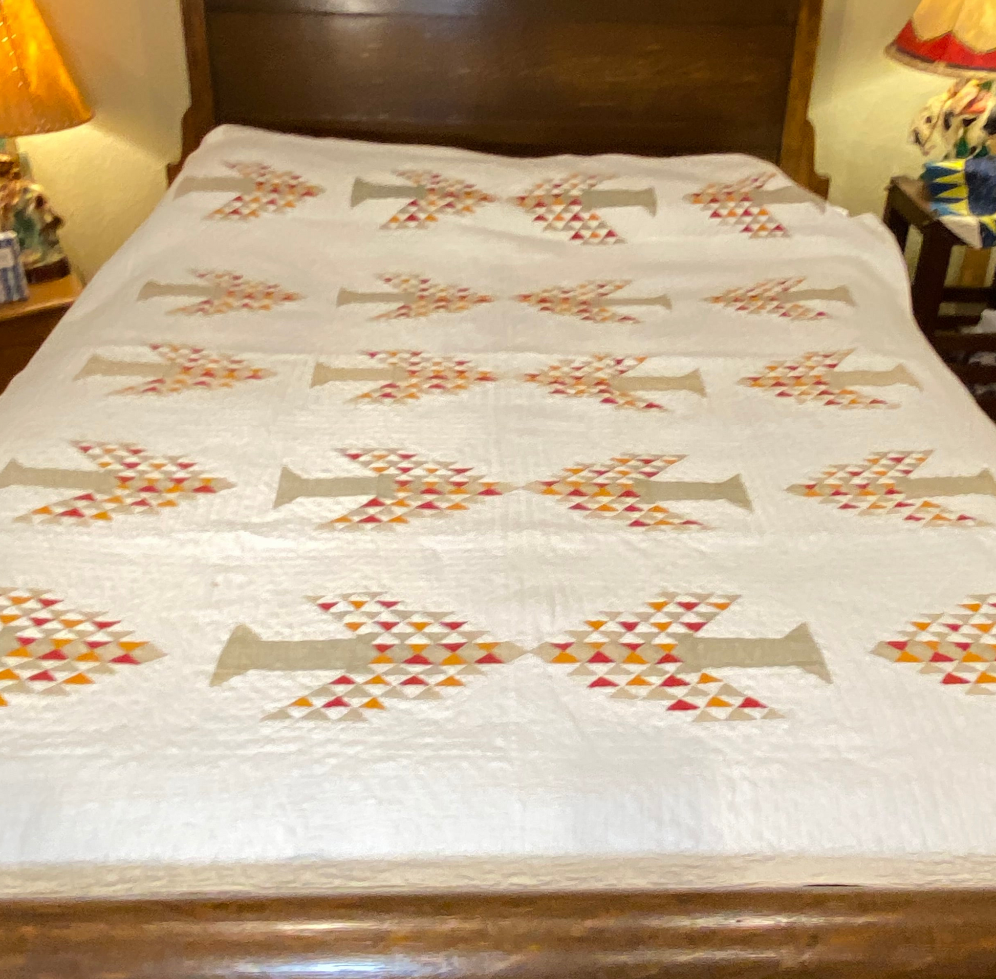 Full image of the Tree of Life quilt as show on a queen bed